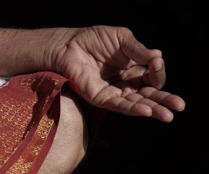 Close up on hands in a meditative mudra position.